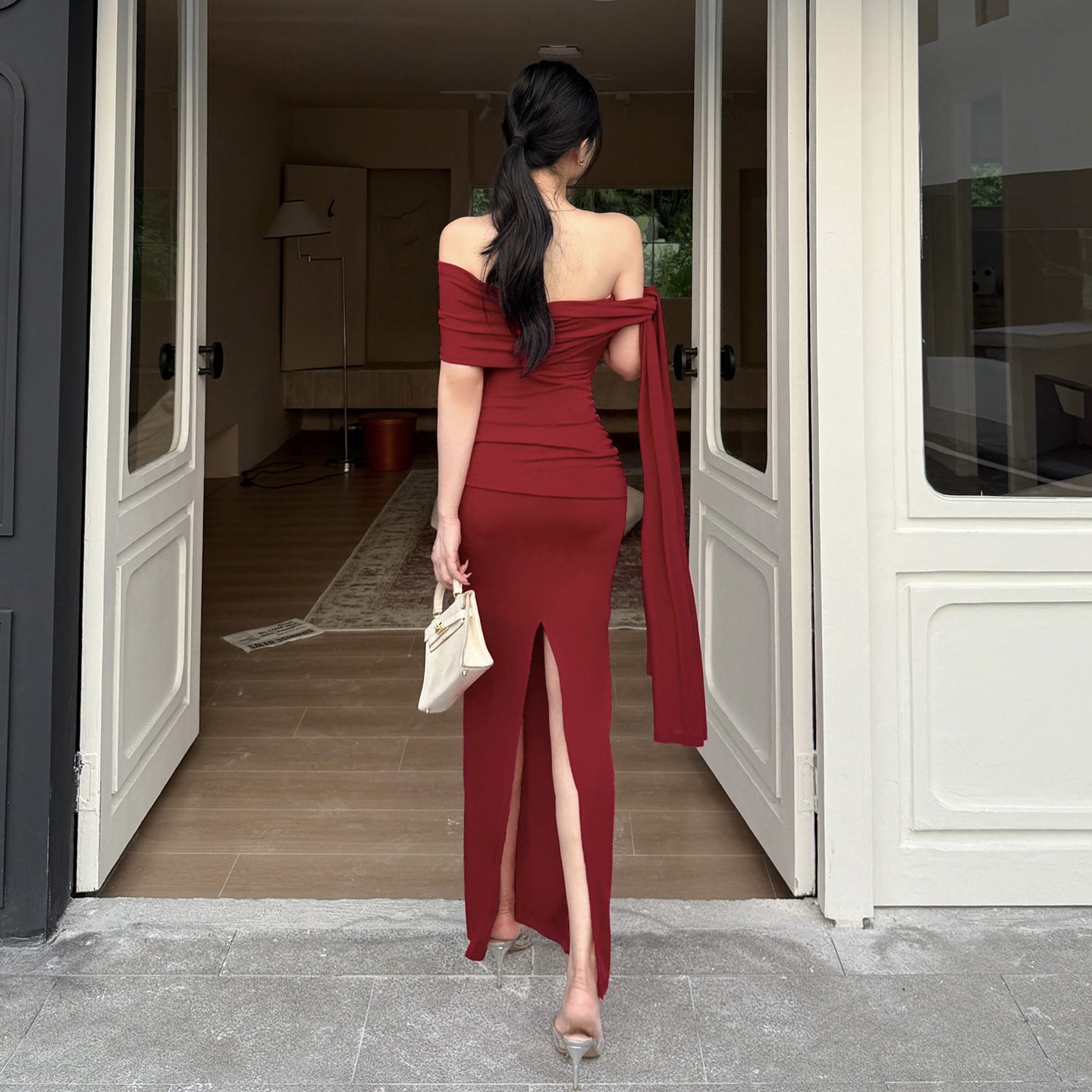 Waist tied dress with slanted shoulders and exposed shoulders